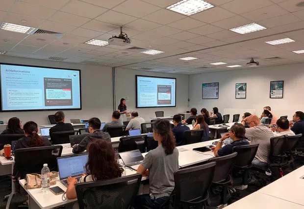 Classroom of professionals following a live AI training demo